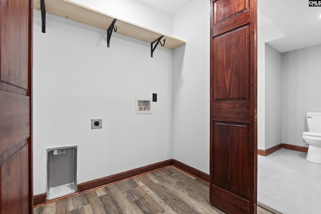 kitchen featuring beam ceiling, light stone countertops, hanging light fixtures, and wood-type flooring