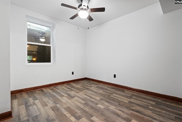 empty room featuring ceiling fan and dark wood-type flooring