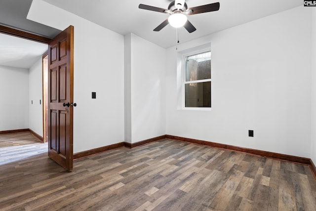 empty room featuring ceiling fan and dark hardwood / wood-style flooring