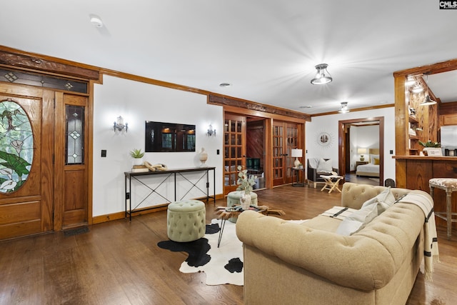 living room with french doors, dark wood-type flooring, and ornamental molding