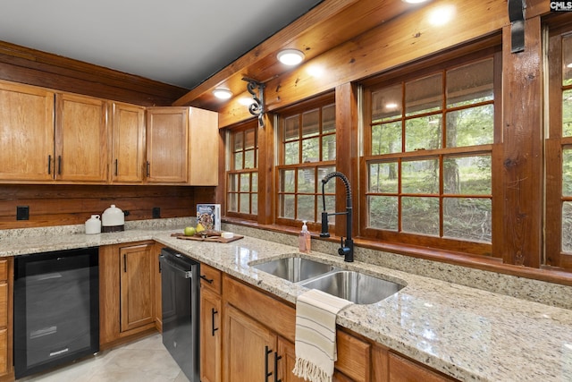 kitchen featuring light stone countertops, sink, beverage cooler, and black dishwasher