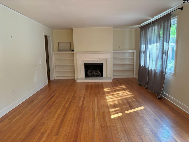 unfurnished living room with hardwood / wood-style flooring