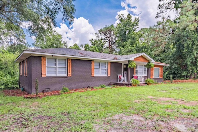 ranch-style house with a front yard and covered porch