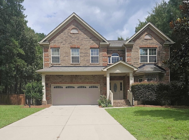 view of front of house with driveway, brick siding, a front lawn, and an attached garage