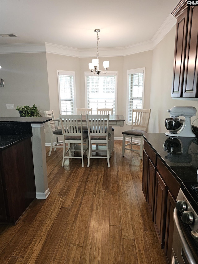 dining room featuring ornamental molding, a wealth of natural light, and dark wood finished floors