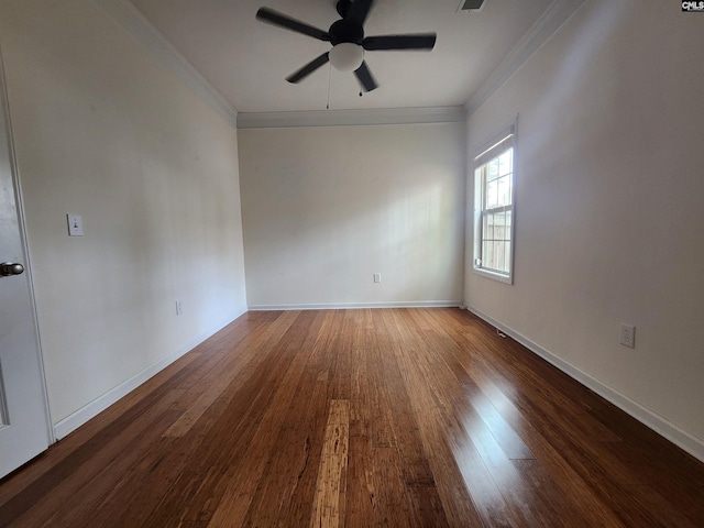 empty room featuring crown molding, visible vents, a ceiling fan, wood finished floors, and baseboards