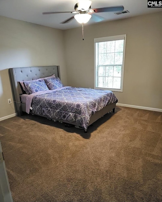 carpeted bedroom with a ceiling fan, visible vents, and baseboards