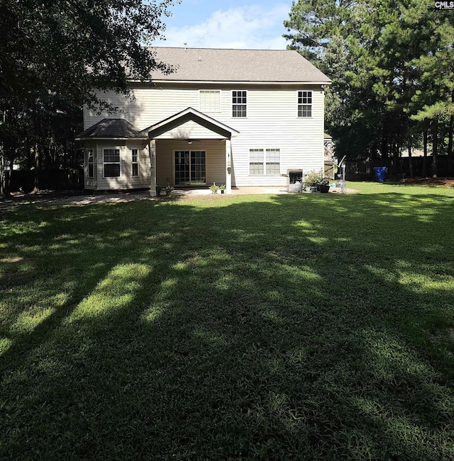 back of property featuring a yard, a patio area, and cooling unit