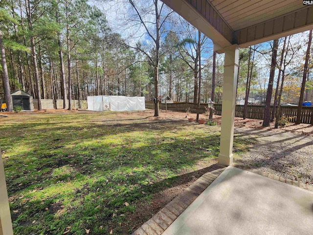 view of yard featuring an outbuilding and a fenced backyard