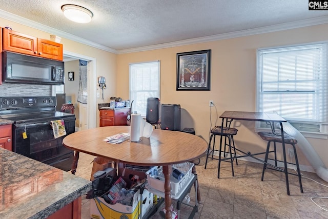 dining area with tile patterned floors, ornamental molding, a healthy amount of sunlight, and a textured ceiling