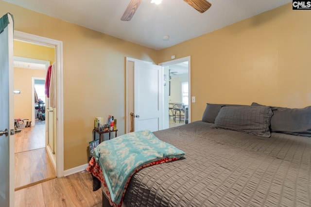 bedroom with light hardwood / wood-style floors and ceiling fan