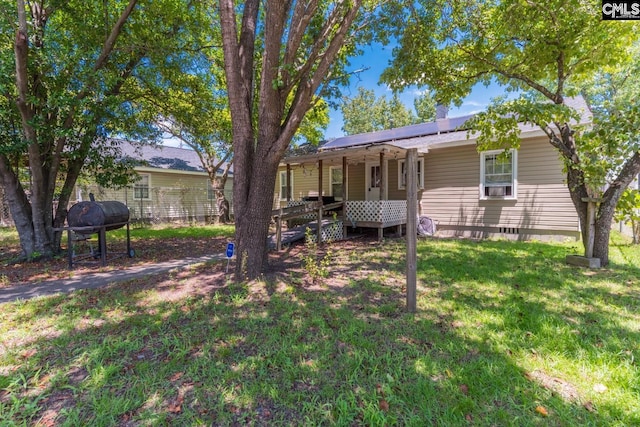 back of house featuring a wooden deck and a lawn