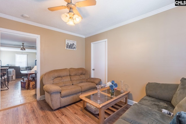 tiled living room featuring a textured ceiling, ceiling fan, and ornamental molding