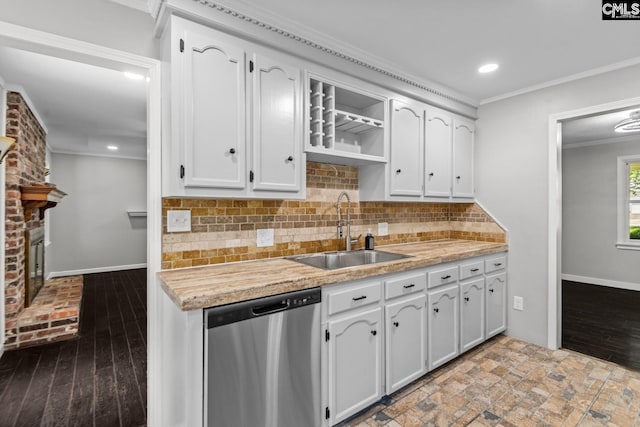 kitchen with sink, dishwasher, white cabinetry, backsplash, and ornamental molding