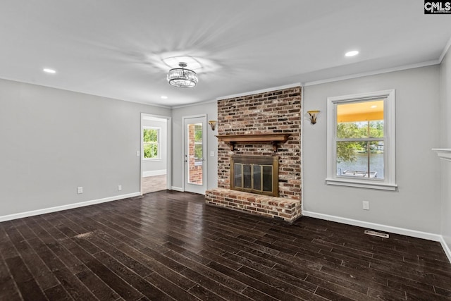 unfurnished living room featuring crown molding, dark wood-type flooring, and a fireplace