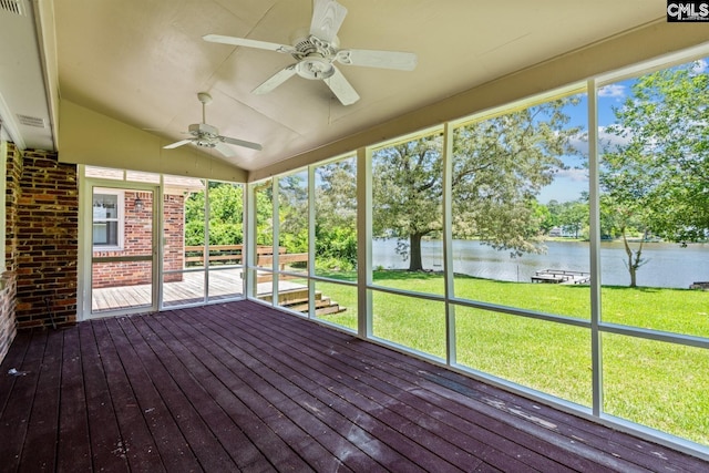 unfurnished sunroom featuring vaulted ceiling, ceiling fan, and a water view