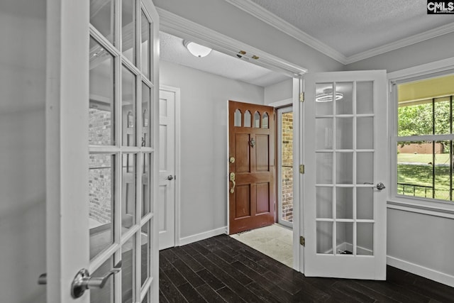 foyer featuring ornamental molding, dark hardwood / wood-style floors, and a textured ceiling