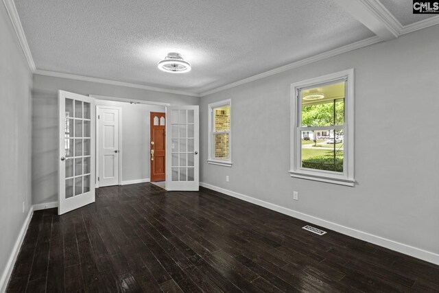 spare room with crown molding, a textured ceiling, dark hardwood / wood-style flooring, and french doors