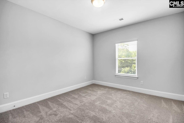 carpeted empty room featuring visible vents and baseboards