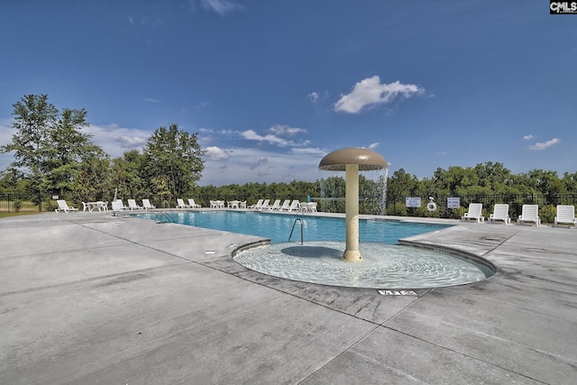 pool with a patio and fence