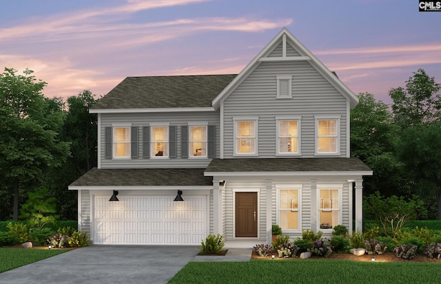 view of front of house featuring a yard and a garage