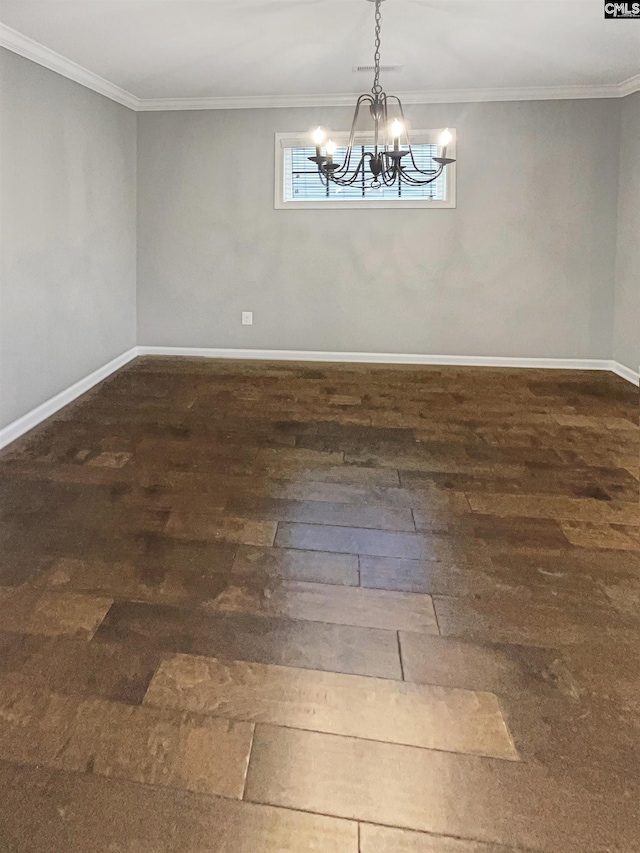 spare room with a notable chandelier, ornamental molding, and dark hardwood / wood-style floors