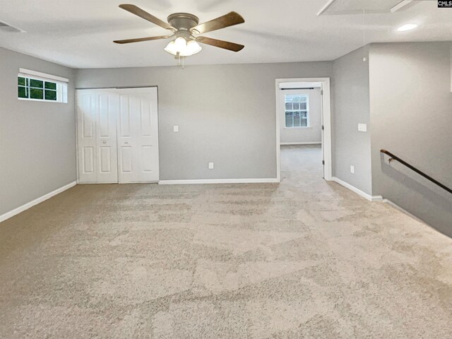 interior space featuring ceiling fan and light colored carpet