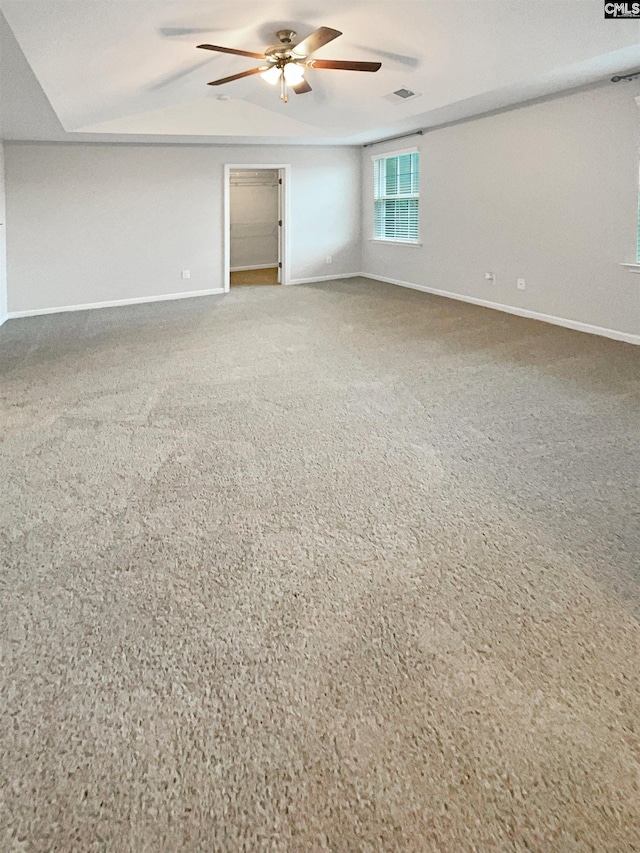 unfurnished room with ceiling fan, vaulted ceiling, and carpet flooring