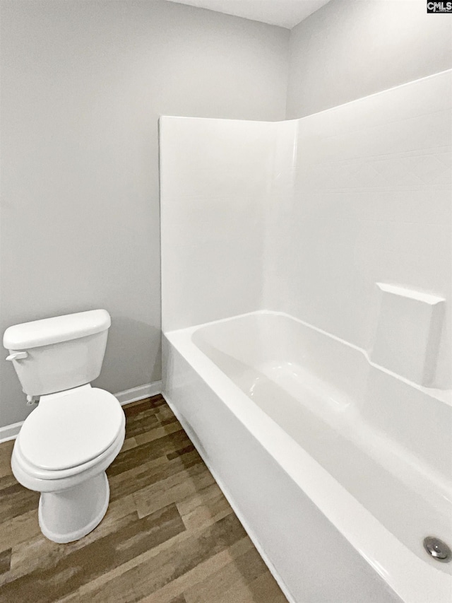 bathroom with toilet and hardwood / wood-style flooring