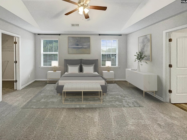 bedroom with lofted ceiling, ceiling fan, and dark colored carpet