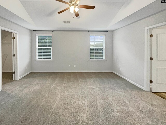 carpeted spare room with ceiling fan and lofted ceiling