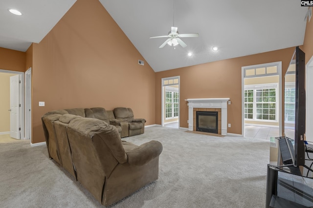 living room featuring ceiling fan, high vaulted ceiling, light carpet, and a fireplace