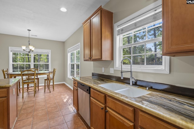 kitchen with sink, a notable chandelier, stainless steel dishwasher, and plenty of natural light