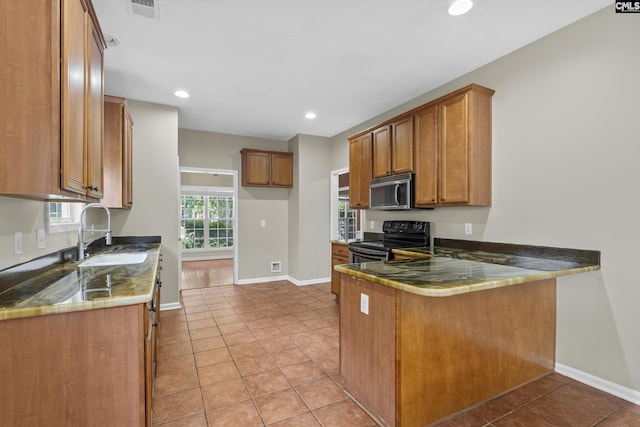 kitchen featuring sink, light tile patterned flooring, black electric range oven, and kitchen peninsula