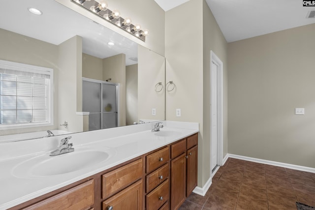 bathroom featuring a shower with door, tile patterned floors, and vanity