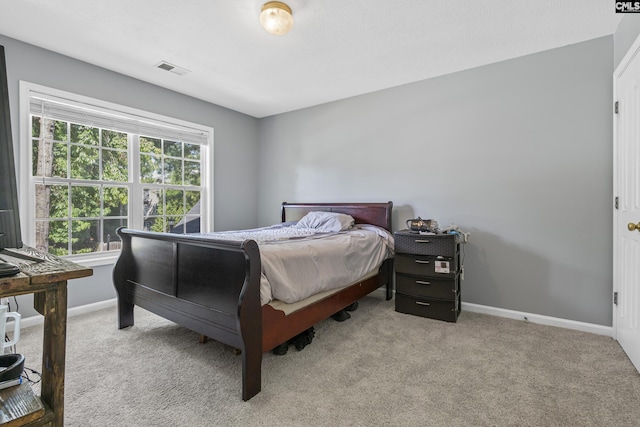 bedroom with light colored carpet