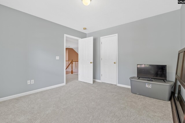 interior space with light colored carpet and lofted ceiling