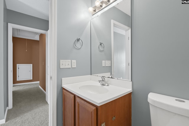 bathroom with toilet and vanity