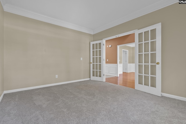 unfurnished room with french doors, crown molding, and carpet flooring