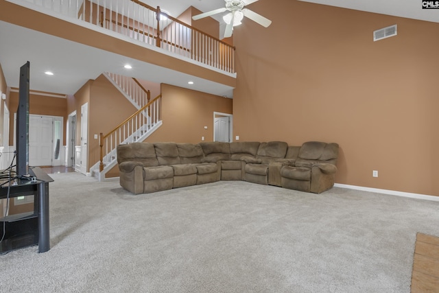 carpeted living room featuring ceiling fan and high vaulted ceiling