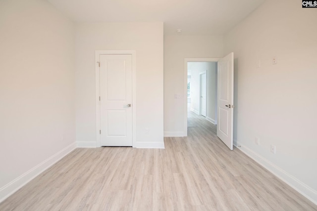 empty room with light hardwood / wood-style floors