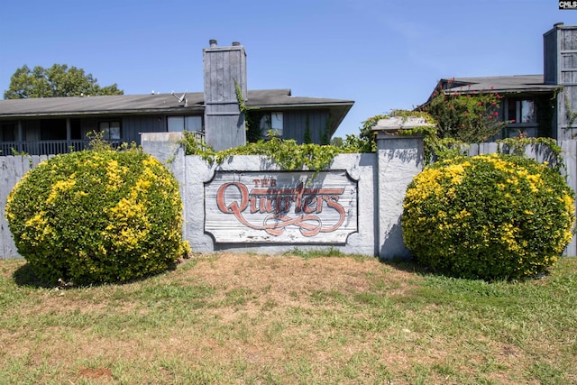 community / neighborhood sign with a lawn