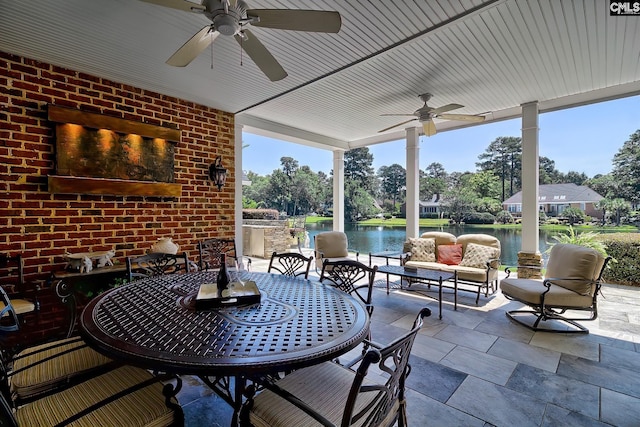 view of patio featuring a water view, ceiling fan, and outdoor lounge area