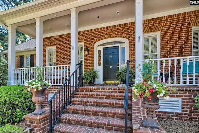 view of exterior entry featuring a porch