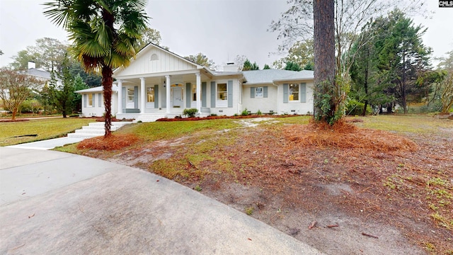 neoclassical / greek revival house with crawl space, covered porch, and a front lawn