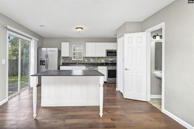 817 Wickham Ln, Columbia, SC 29229 - kitchen with backsplash, white cabinetry, stainless steel appliances, baseboards, and dark countertops