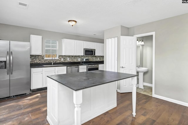 817 Wickham Ln, Columbia, SC 29229 - kitchen featuring decorative backsplash, a sink, dark countertops, visible vents, and appliances with stainless steel finishes