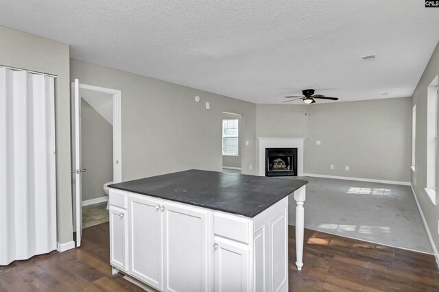 817 Wickham Ln, Columbia, SC 29229 - kitchen featuring dark wood finished floors, dark countertops, ceiling fan, and white cabinetry