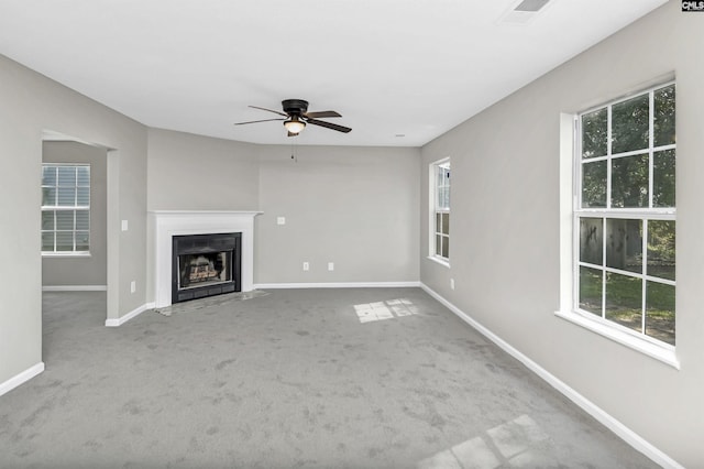 817 Wickham Ln, Columbia, SC 29229 - unfurnished living room featuring a fireplace with flush hearth, visible vents, carpet, baseboards, and a ceiling fan