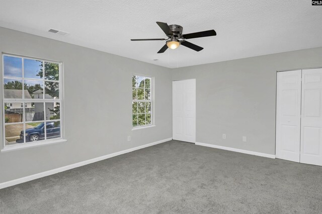 817 Wickham Ln, Columbia, SC 29229 - unfurnished bedroom featuring baseboards, a textured ceiling, visible vents, and dark carpet